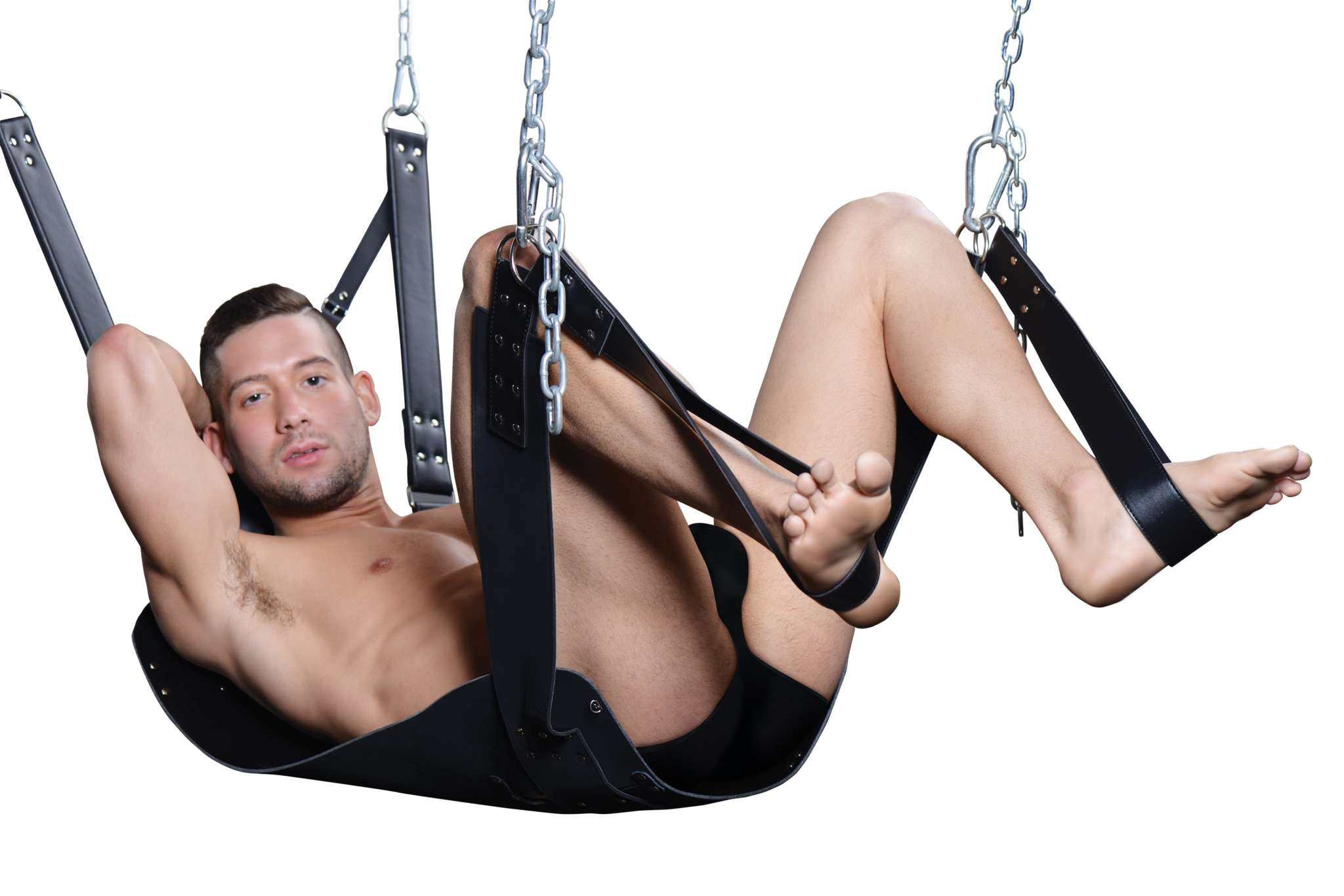 Man in black leather bondage gear suspended in a chain-linked swing.