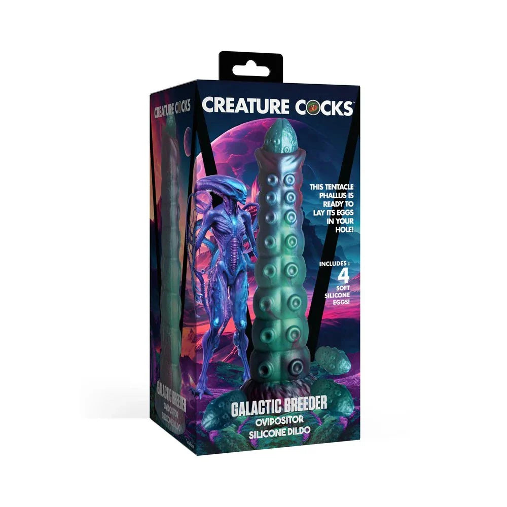 Creature Cocks Galactic Breeder Ovipositor Silicone Dildo in packaging, showcasing teal, red, and blue hues with textured design and 4 silicone eggs for fantasy exploration.