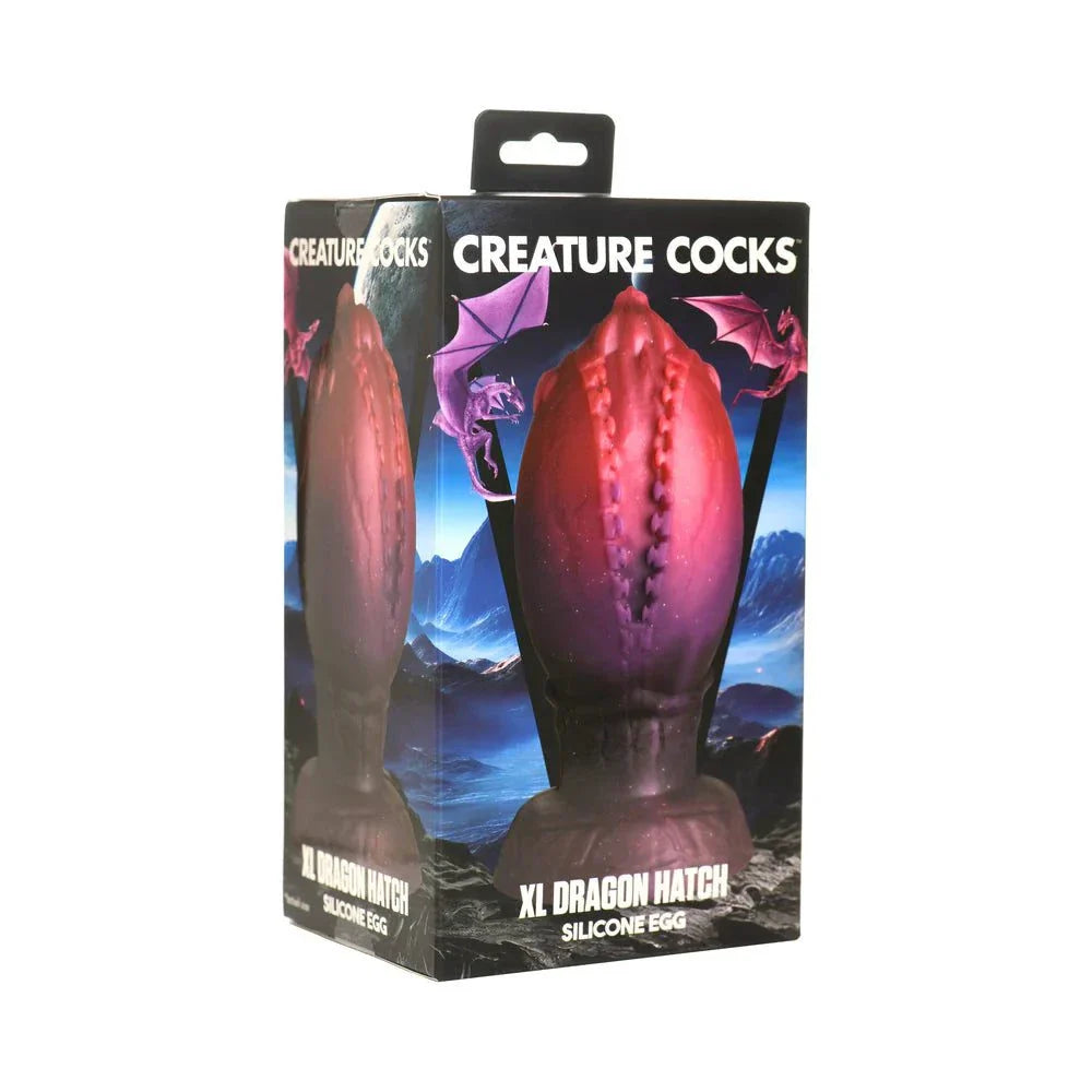 Creature Cocks Dragon Hatch Silicone Egg XL in packaging with glittery red and brown textured design.