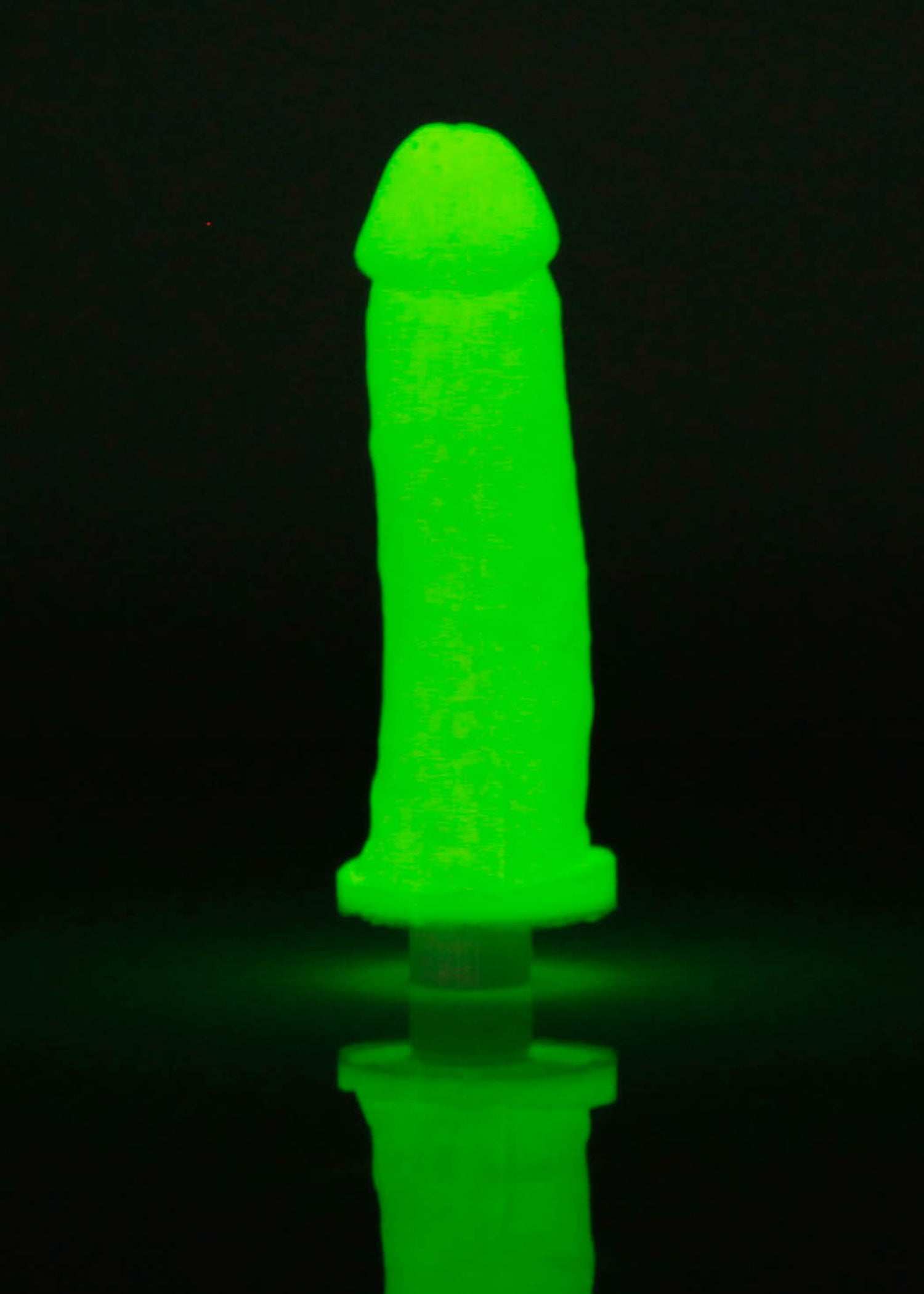 Clone-a-Willy Kit glowing silicone replica in vibrant neon green.