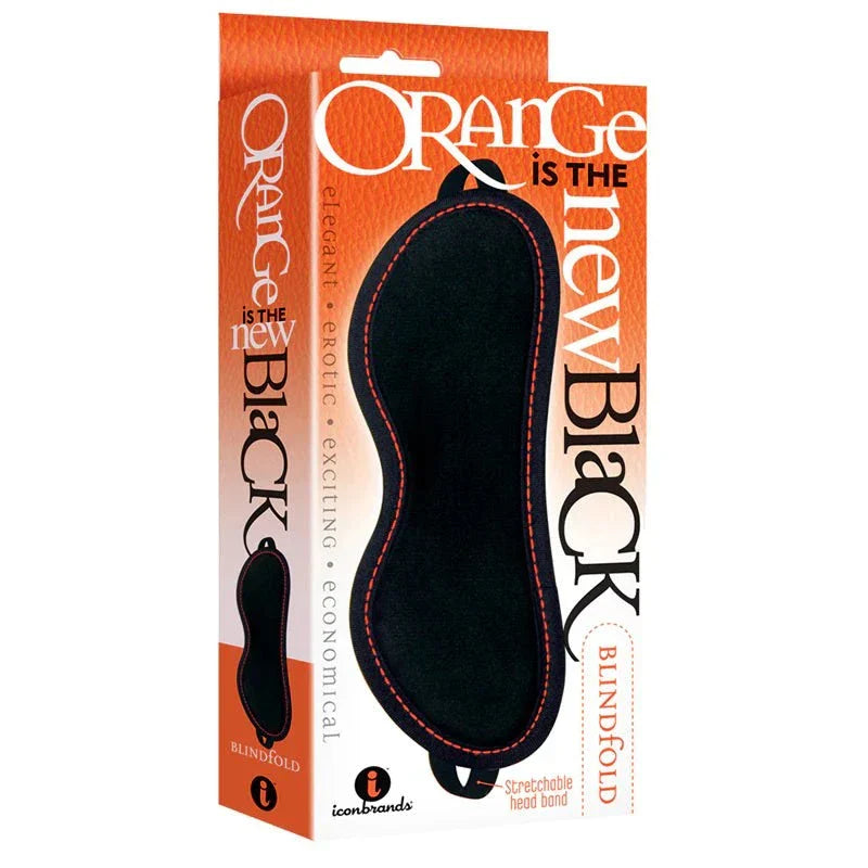 Faux leather blindfold with furry orange lining in packaging, BDSM accessory.