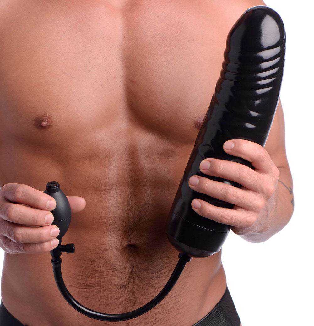 Black XXL inflatable dildo with pump held by shirtless man