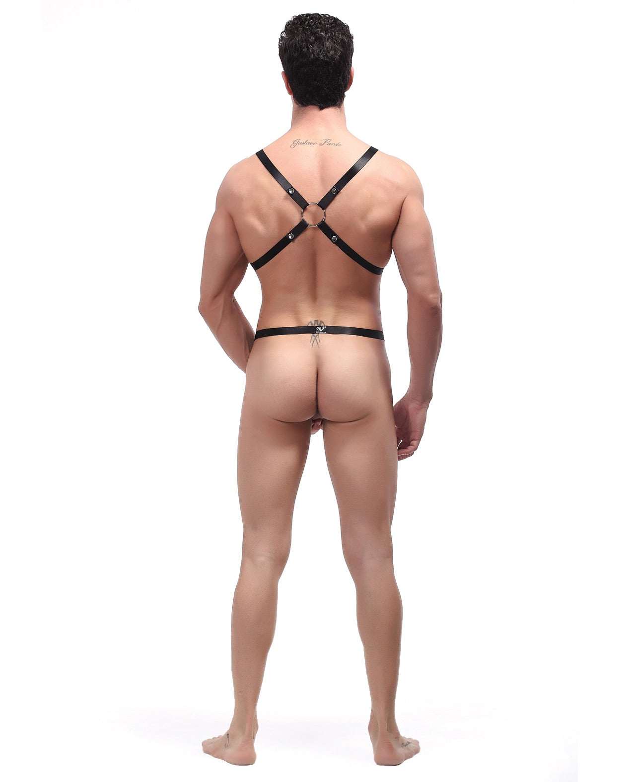 Rear view of a male model wearing a black rip off harness set with adjustable straps and open back design.