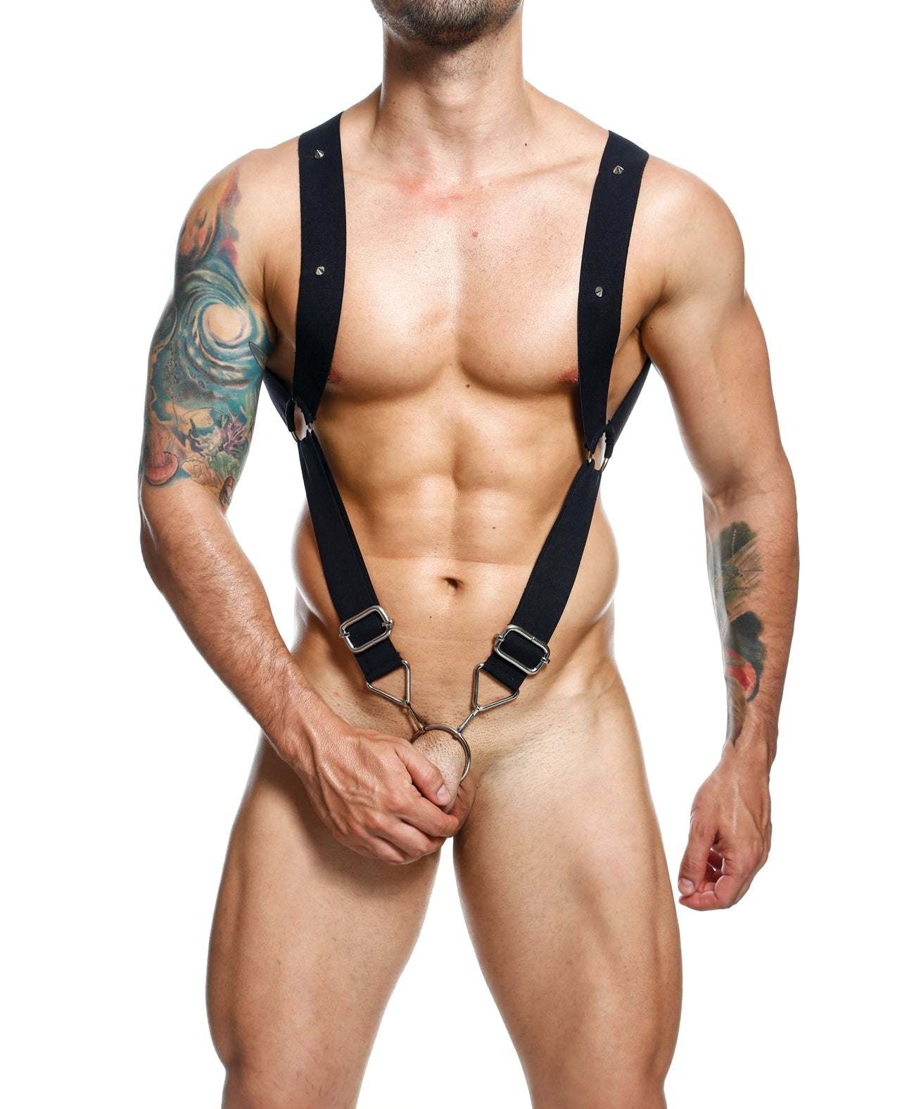 Man wearing black Dngeon Straight Back Harness with metal rings and elastic straps, showcasing muscular torso and tattoos