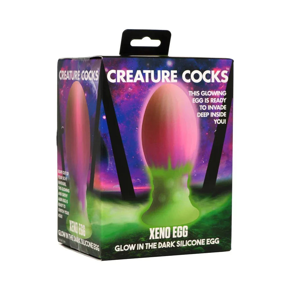 Creature Cocks Xeno Egg glow-in-the-dark silicone sex toy in vibrant pink and green packaging
