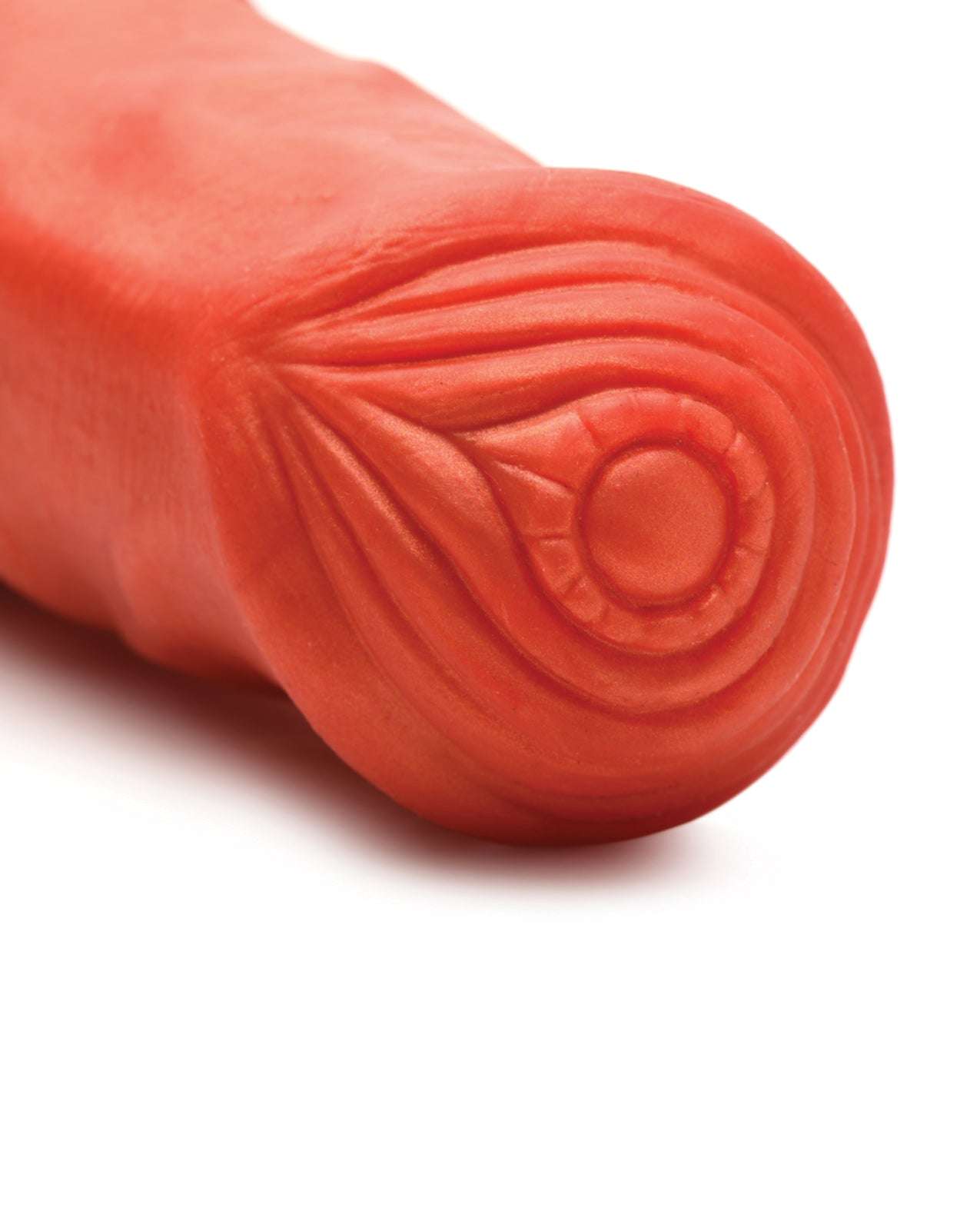 Close-up of the orange textured head of the Creature Cocks Centaur Silicone Dildo with detailed ridges and rings on a white background
