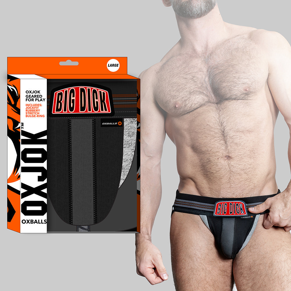 Black Oxballs Oxjok Bulger Pumper-Sack jockstrap with padded pouch and bold "BIG DICK" waistband label worn by muscular man