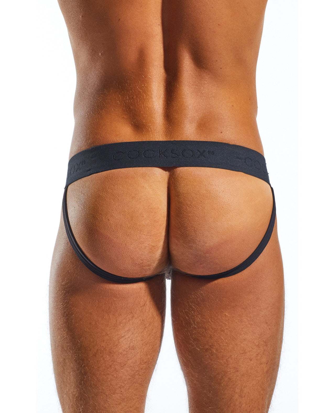 Back view of a man wearing a black Cocksox Enhancing Pouch Jockstrap, size large, showcasing the wide branded waistband and ergonomic design.