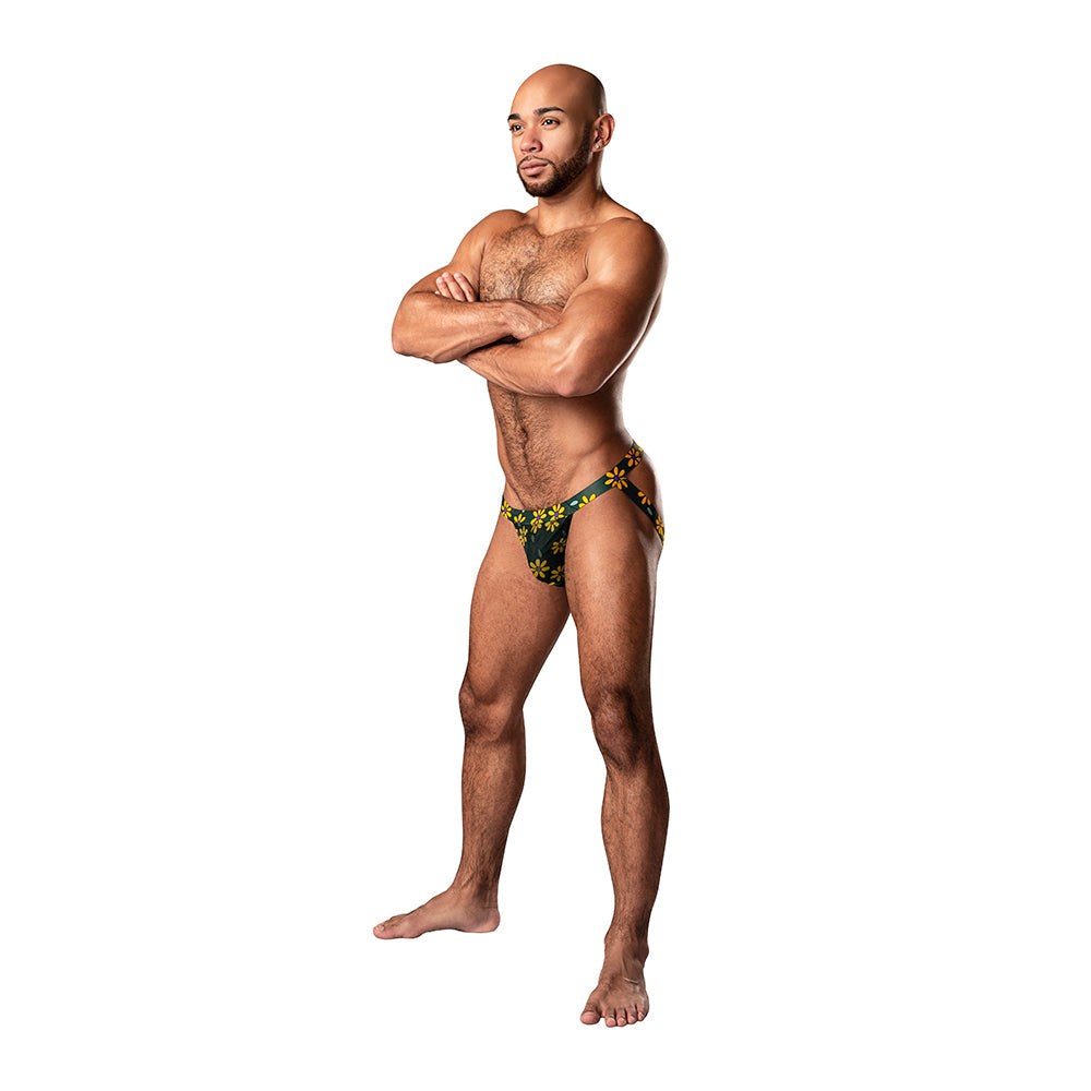 Male model wearing Male Power Petal Power daisy print jockstrap in black and yellow with sheer mesh and low cut waistband