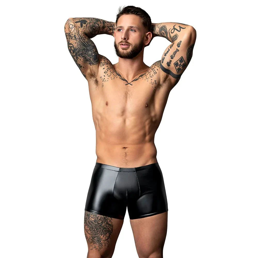 Man wearing black Male Power Liquid Onyx 2.0 Short with tattoos, posing with arms behind head