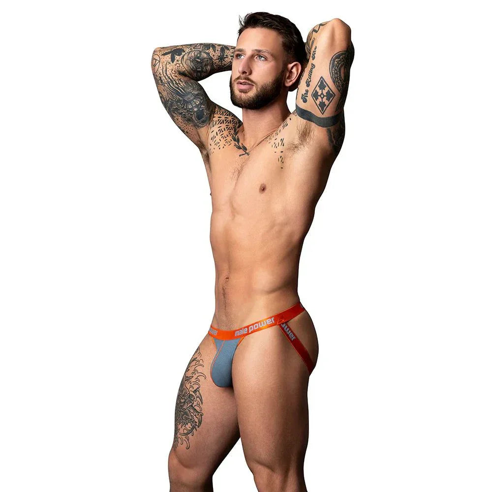 Male model wearing Male Power The Ultimate Duo CRC Uplift Jock in grey and red waistband, showcasing fit and support.