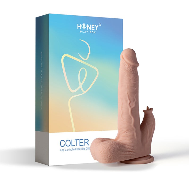 Honey Play Box Colter app controlled realistic thrusting dildo with clit licker and suction base next to product packaging