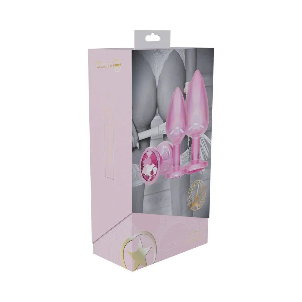 Ouch International Paris Collection pink metal anal plug set with three iridescent, jewel-encrusted aluminum plugs in small, medium, and large sizes