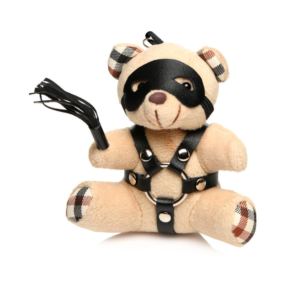 Master Series BDSM Teddy Bear keychain with light peach fur, black faux leather harness, eye mask, and mini flogger accessory.