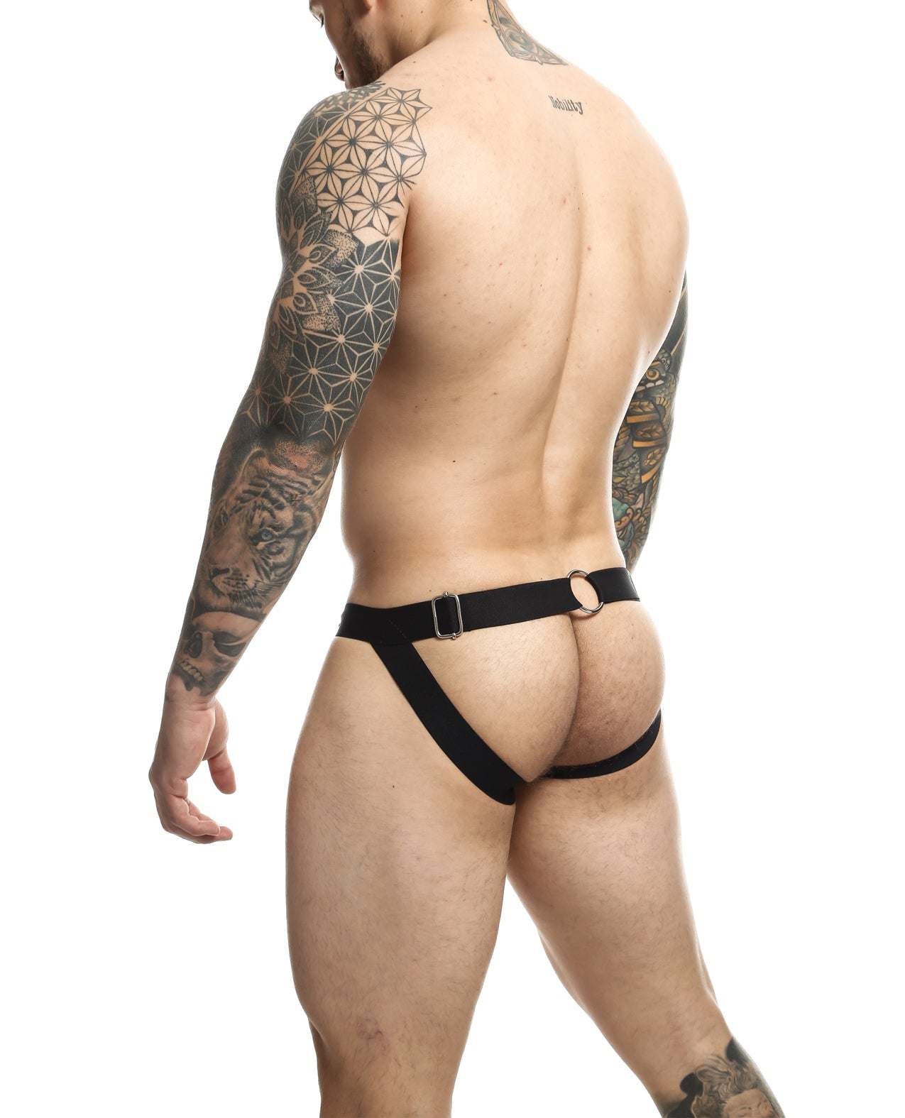Man wearing black Dngeon Chain Jockstrap showing back view with hip straps and open rear design.