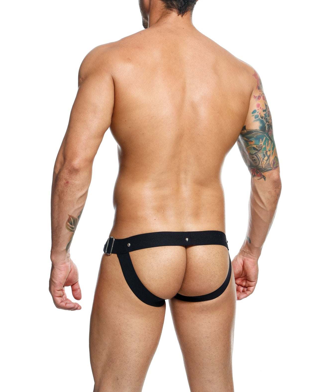 Male model wearing black Dngeon Snap Jockstrap showing minimal back coverage and wide hip straps.
