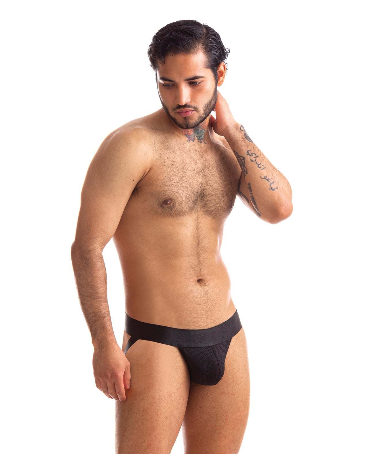 Man wearing black 665 Stealth Jockstrap underwear with supportive fit and sleek design against white background