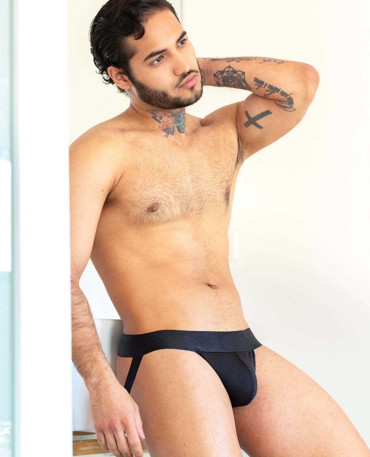 Man modeling black 665 Stealth Jockstrap with mesh pouch and supportive fit
