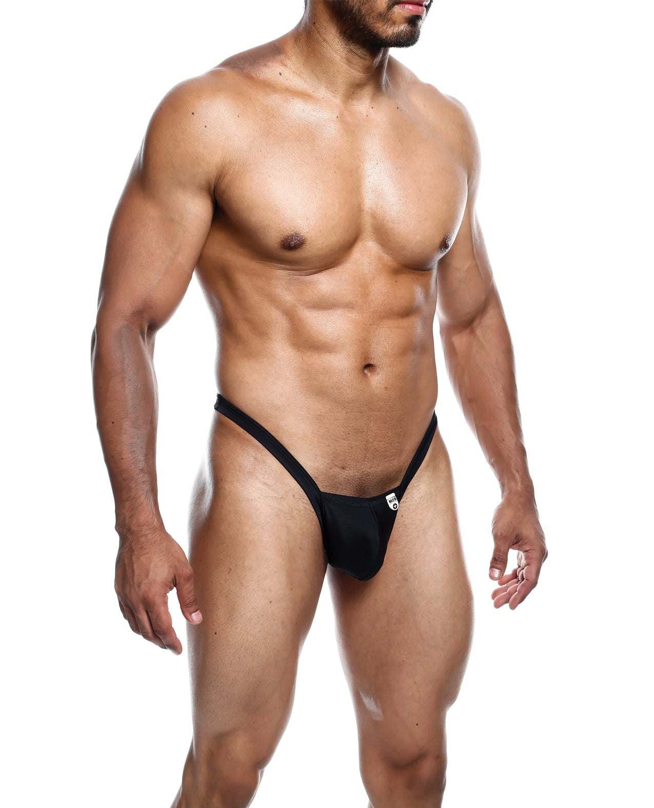 Male model wearing black Male Basics Y Buns Thong with thin V-straps and minimal coverage.