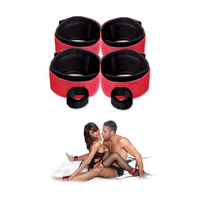 Set of adjustable red and black neoprene wrist and ankle cuffs from Fetish Fantasy Web restraint system with a couple using them on a bed.