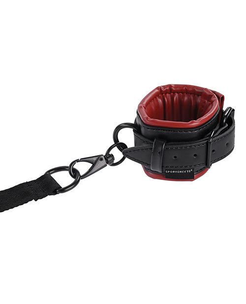 Saffron Under the Bed adjustable restraint cuff in black and red faux leather with secure strap attachment