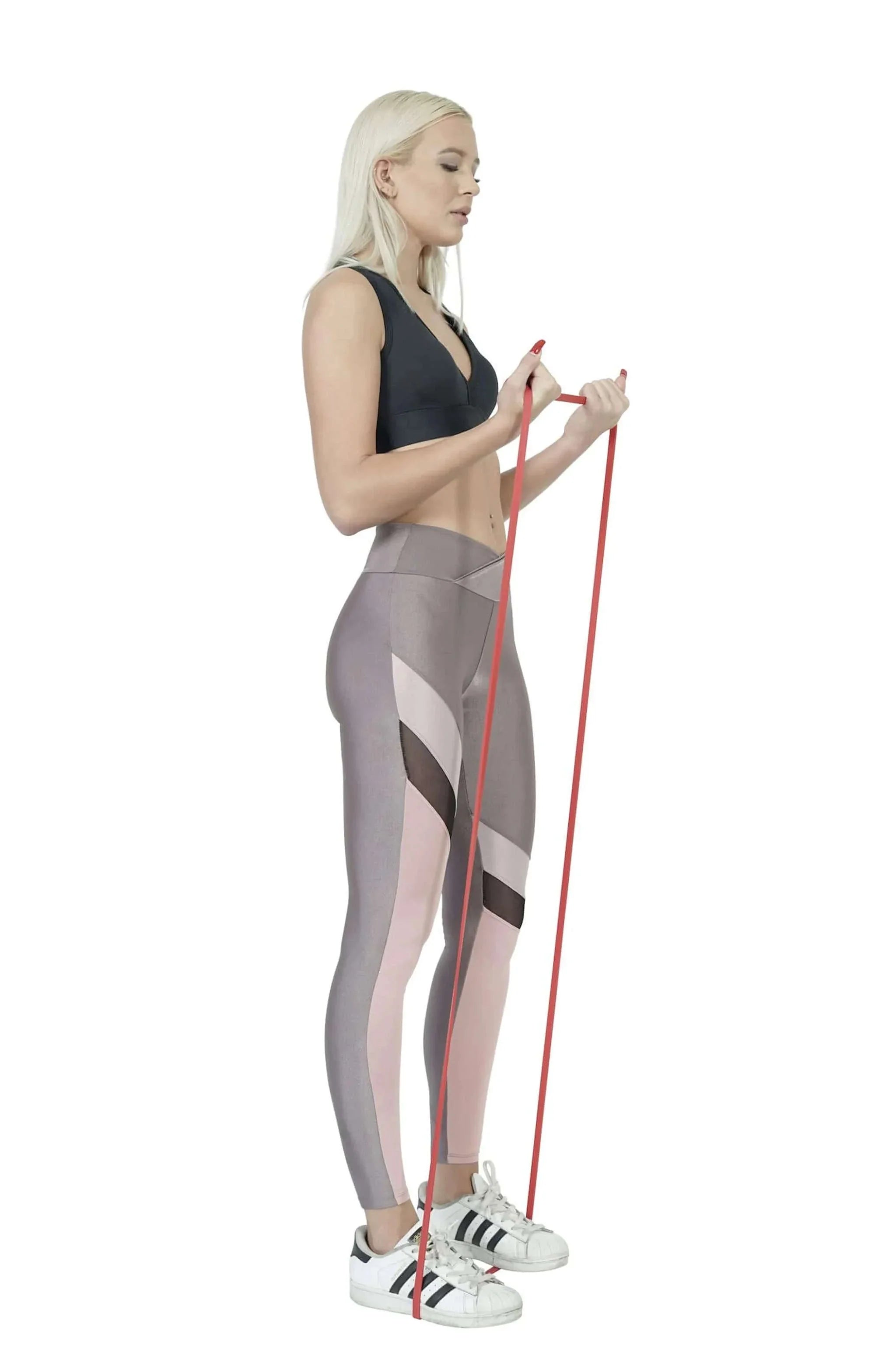 Woman using red powerlifting and pull up exercise resistance band for fitness workout