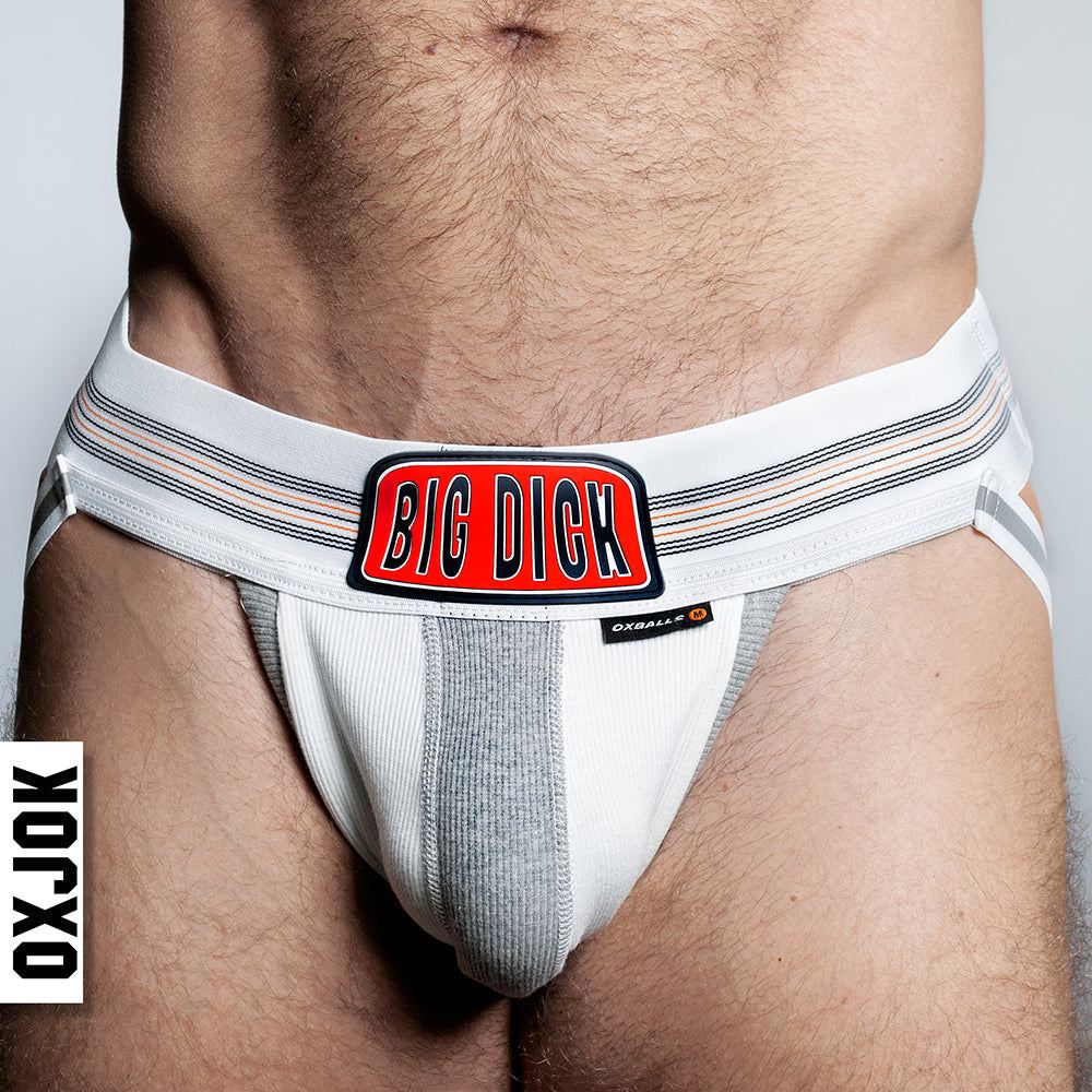 Close-up of a man wearing white Oxballs Oxjok Bulger Pumper-Sack Slider Jock with a big red "BIG DICK" label on waistband