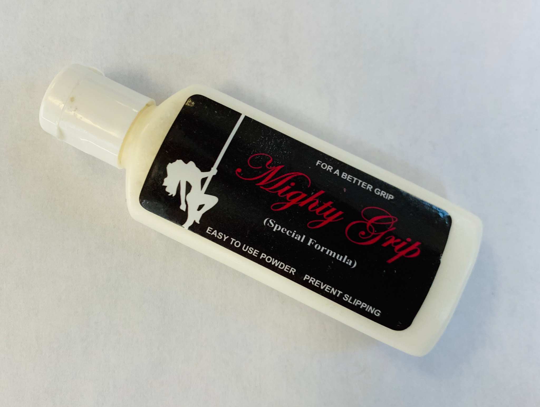 Mighty Grip Special Formula white bottle with black label for enhanced grip and slip prevention
