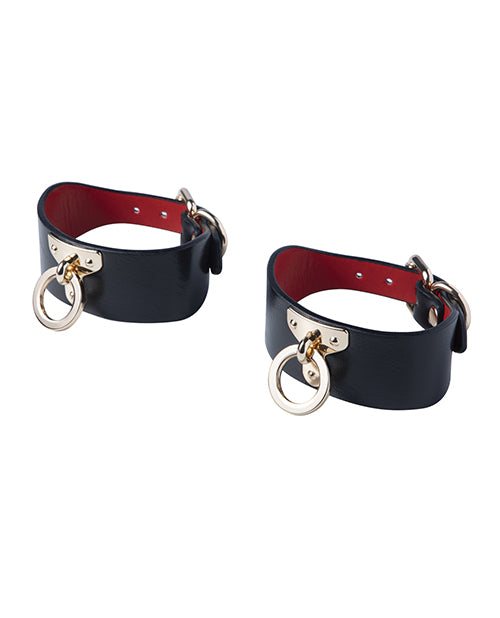 Black and red vegan leather adjustable wrist cuffs with metal rings from Kinky Play Box BDSM Kit