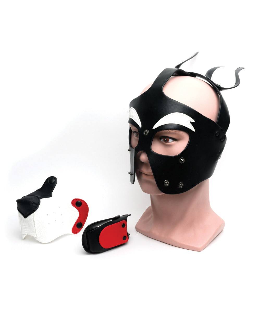 665 Playful Pup Hood in black, white, and red PU material with alloy hardware displayed on a mannequin head with detachable muzzle components nearby.