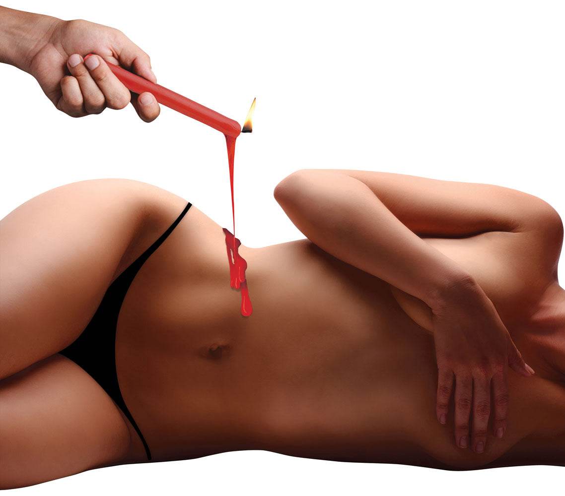 Red Fetish Drip Candle melting warm wax on person's bare torso for intimate sensation play