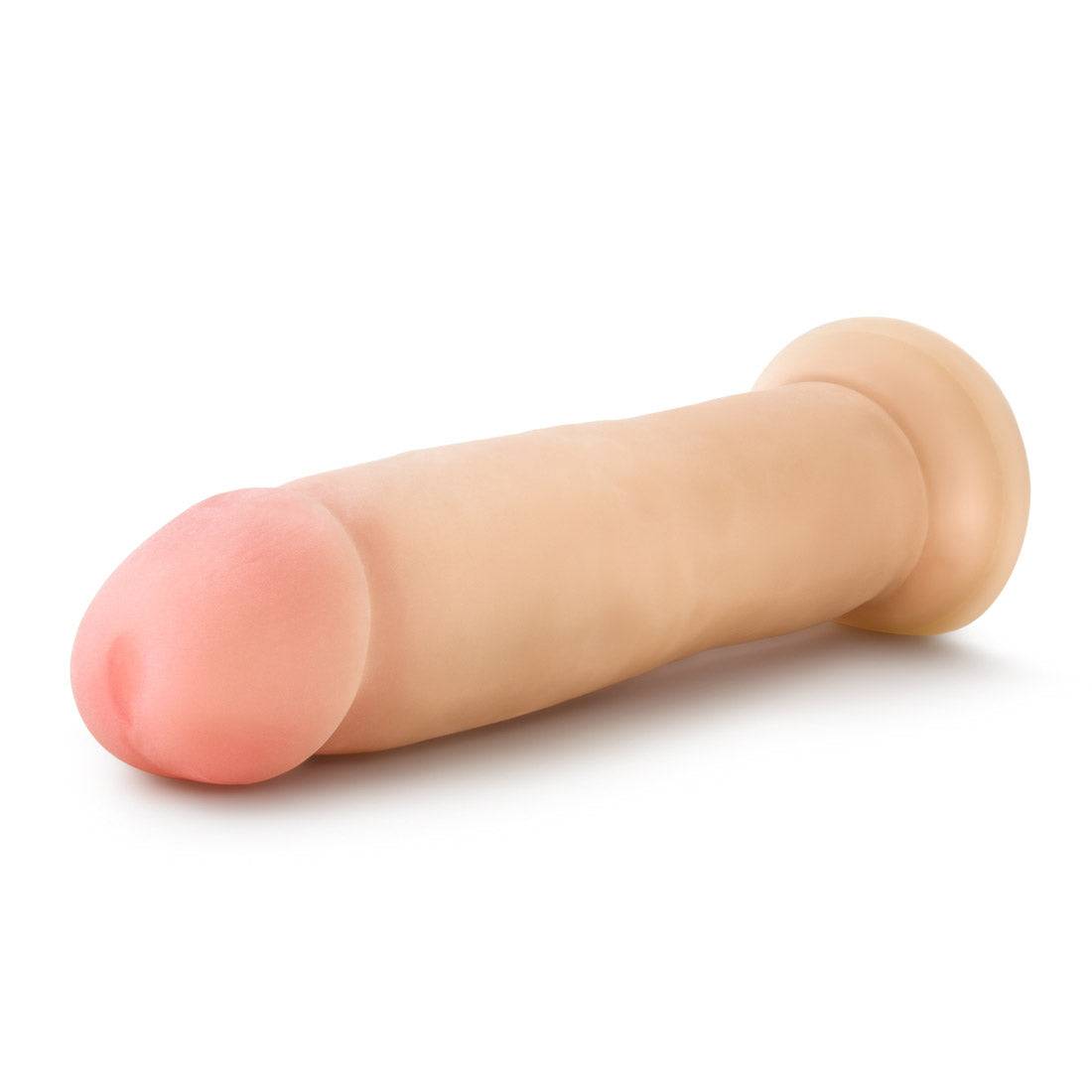 Beige 9.5 inch realistic Sensa Feel Magnum Dong with suction base for hands-free use.