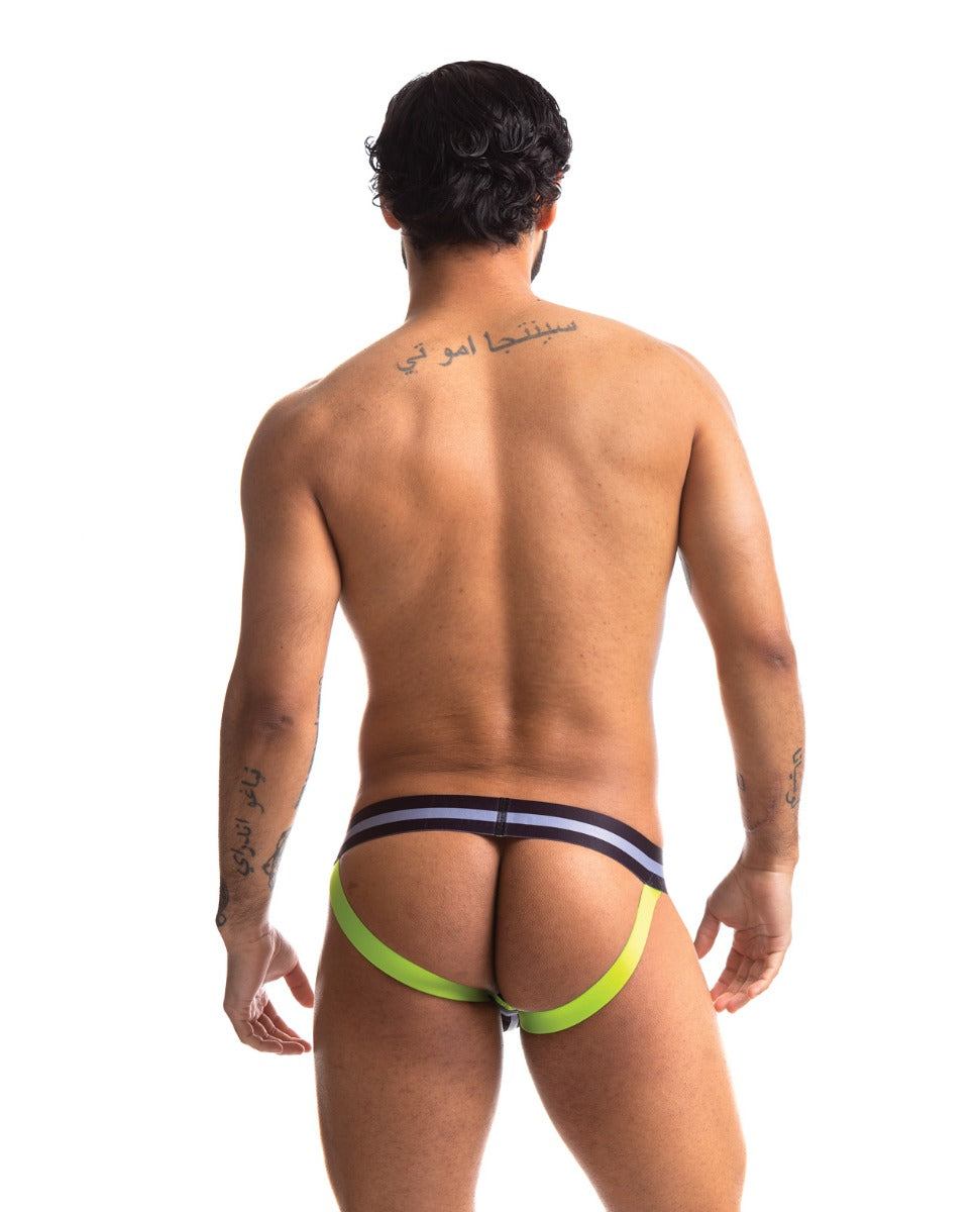 Man wearing Sport Fucker Jersey mesh jockstrap with black waistband and neon green straps from the back