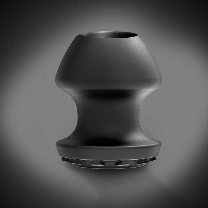 Fort Troff Kum Keeper black silicone storage container with tapered design and removable stopper for versatile intimate use.