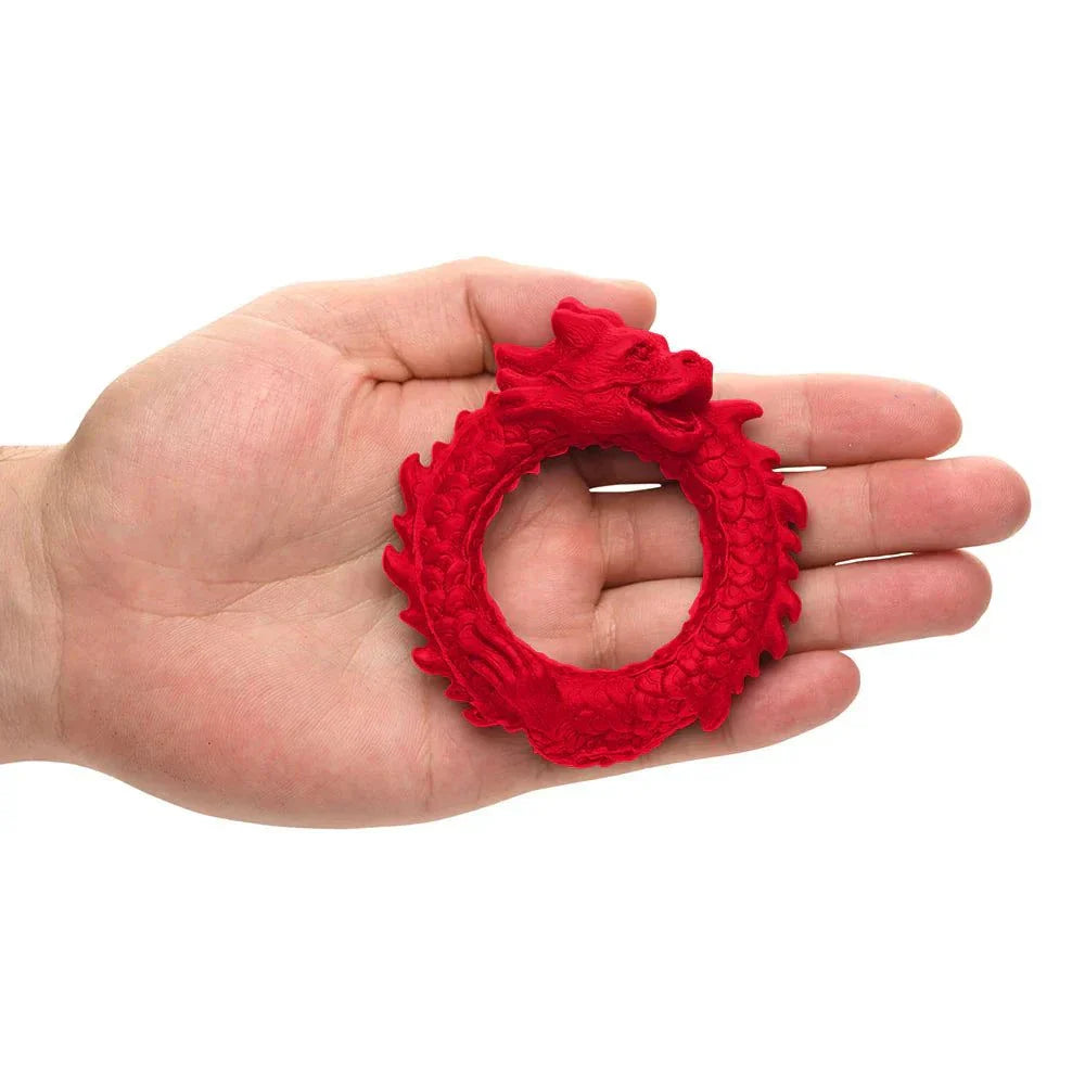 Red silicone cock ring with dragon design held in hand, Creature Cocks Rise of the Dragon model