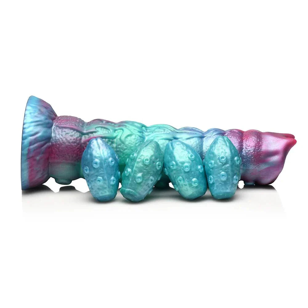 Teal, red, and blue Creature Cocks Galactic Breeder Ovipositor Silicone Dildo with textured bumps and silicone eggs.
