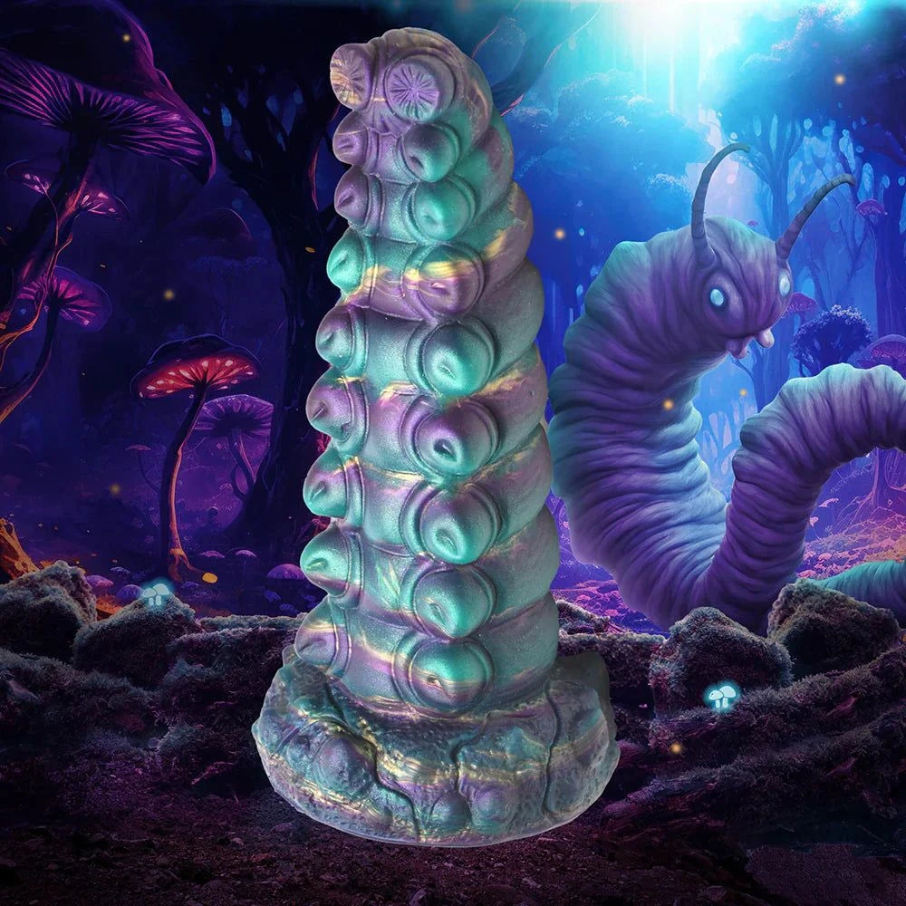 Creature Cocks Chrysalis Silicone Dildo with iridescent teal, purple, gold, and blue colors in a fantasy setting.