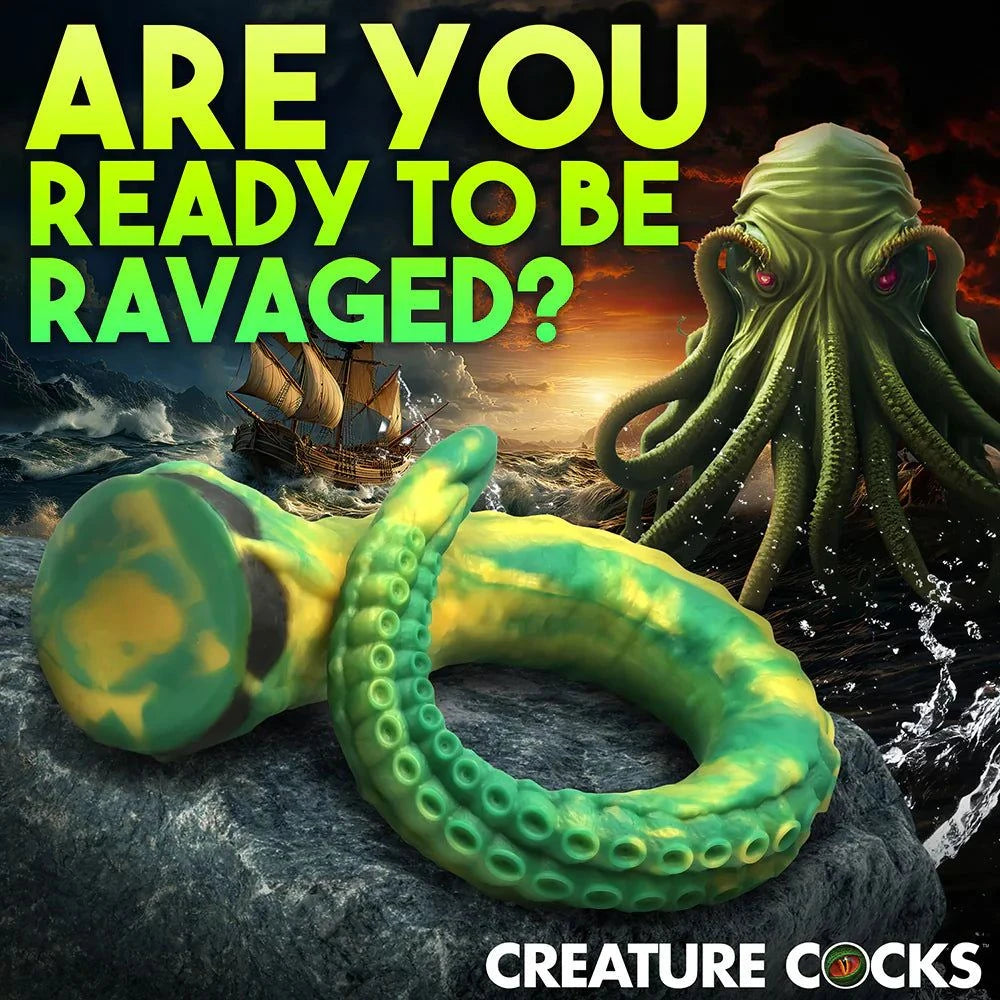 Creature Cocks Titan Tentacle extra long green and yellow silicone dildo with textured suckers and suction cup base against a stormy sea background.