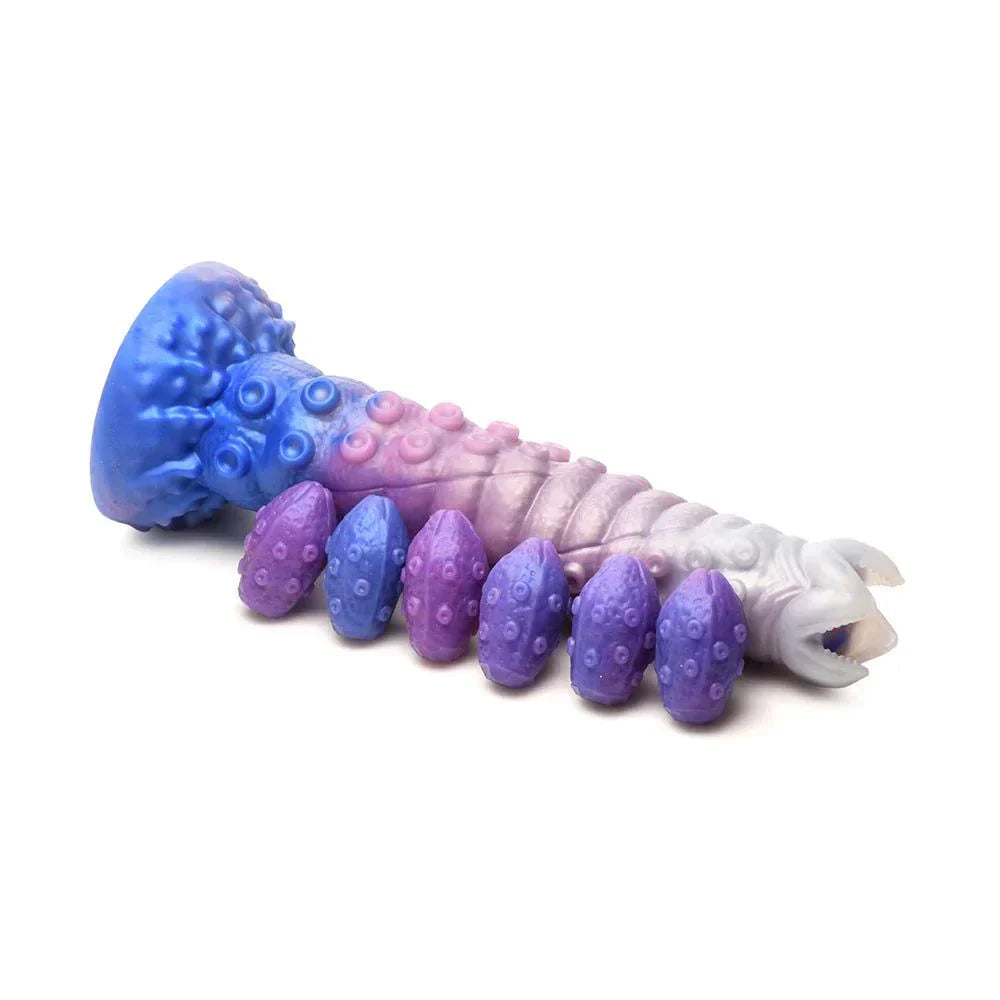 Creature Cocks Tenta-Queen Ovipositor Silicone Dildo with Eggs in vibrant blue, pink, and white, featuring ribbed tentacle shaft with suckers and purple silicone eggs.