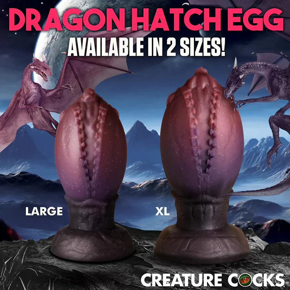 Creature Cocks Dragon Hatch Silicone Egg XL with textured ridges, glittery dark red finish, and dragon-head tip for fantasy pleasure.