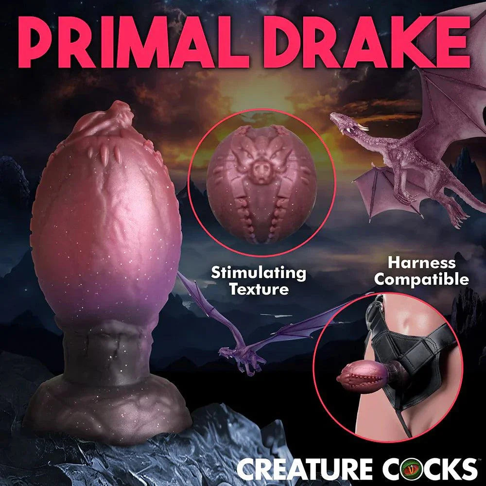 Creature Cocks Dragon Hatch Silicone Egg XL with dragon-themed design, textured ridges, and glittery dark red finish, harness-compatible for fantasy play.