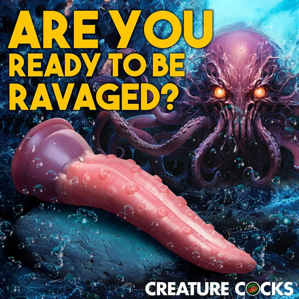 Pink tentacle-shaped silicone dildo with suction cup base against an underwater octopus background, Creature Cocks Octoprobe product.