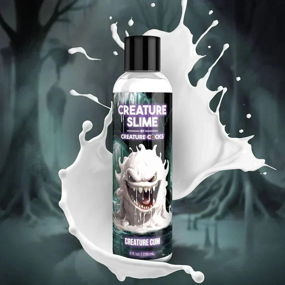 Bottle of Creature Slime Creature Cum unscented lubricant with splashing white liquid background.
