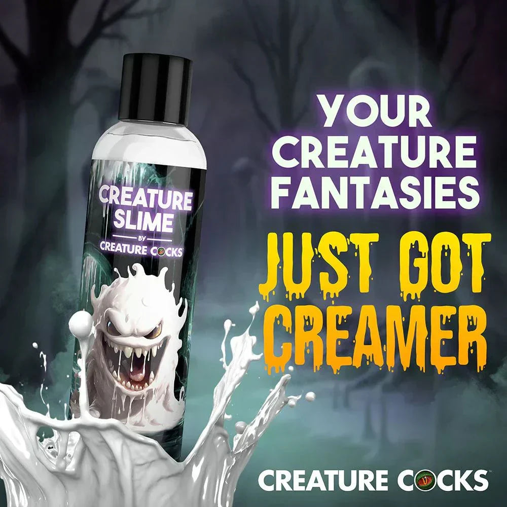 Bottle of Creature Slime Creature Cum unscented jizz lubricant with a spooky creature design and splash effect against a dark forest background.