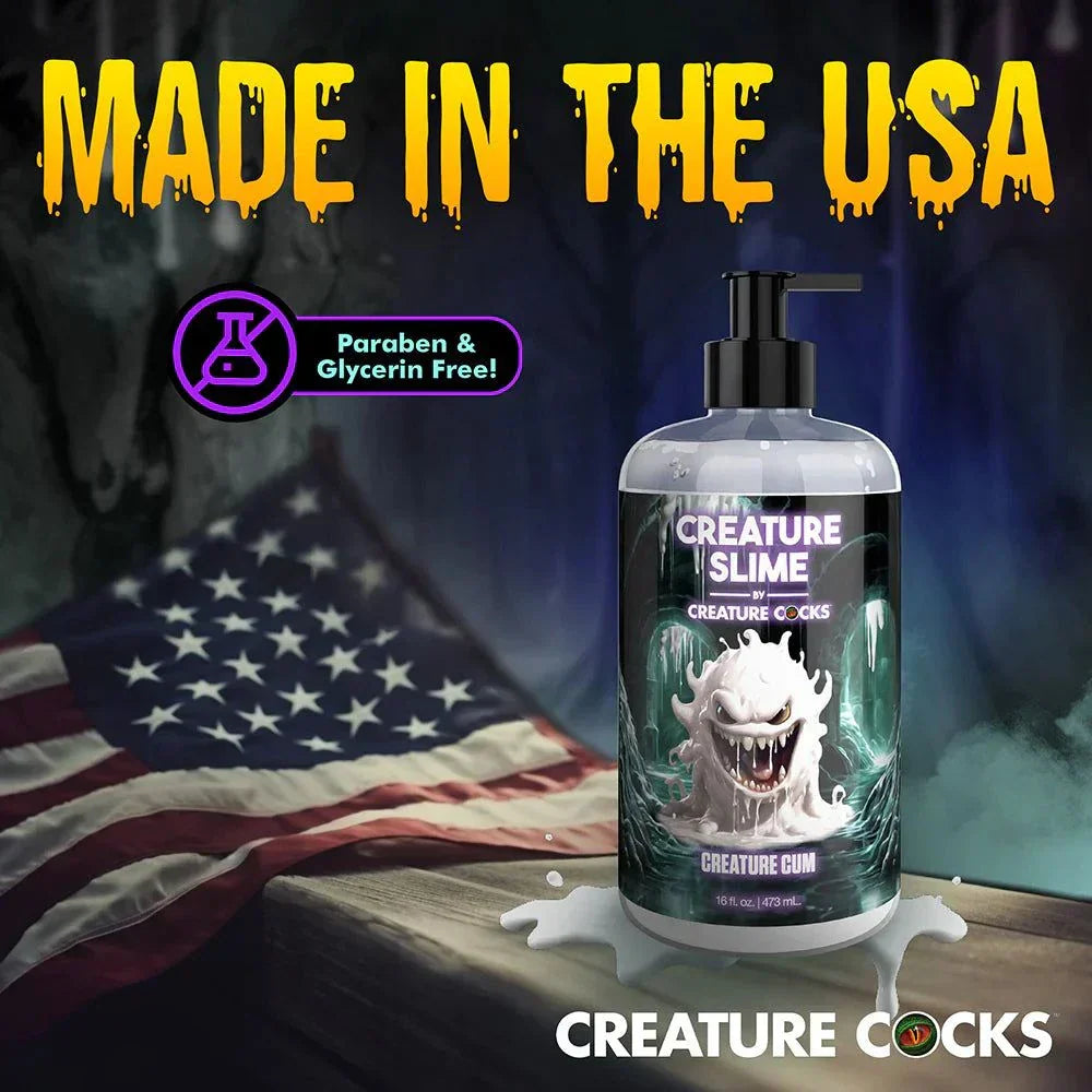 Creature Slime Creature Cum unscented lubricant bottle with monster label, made in USA, paraben and glycerin free, displayed with American flag background