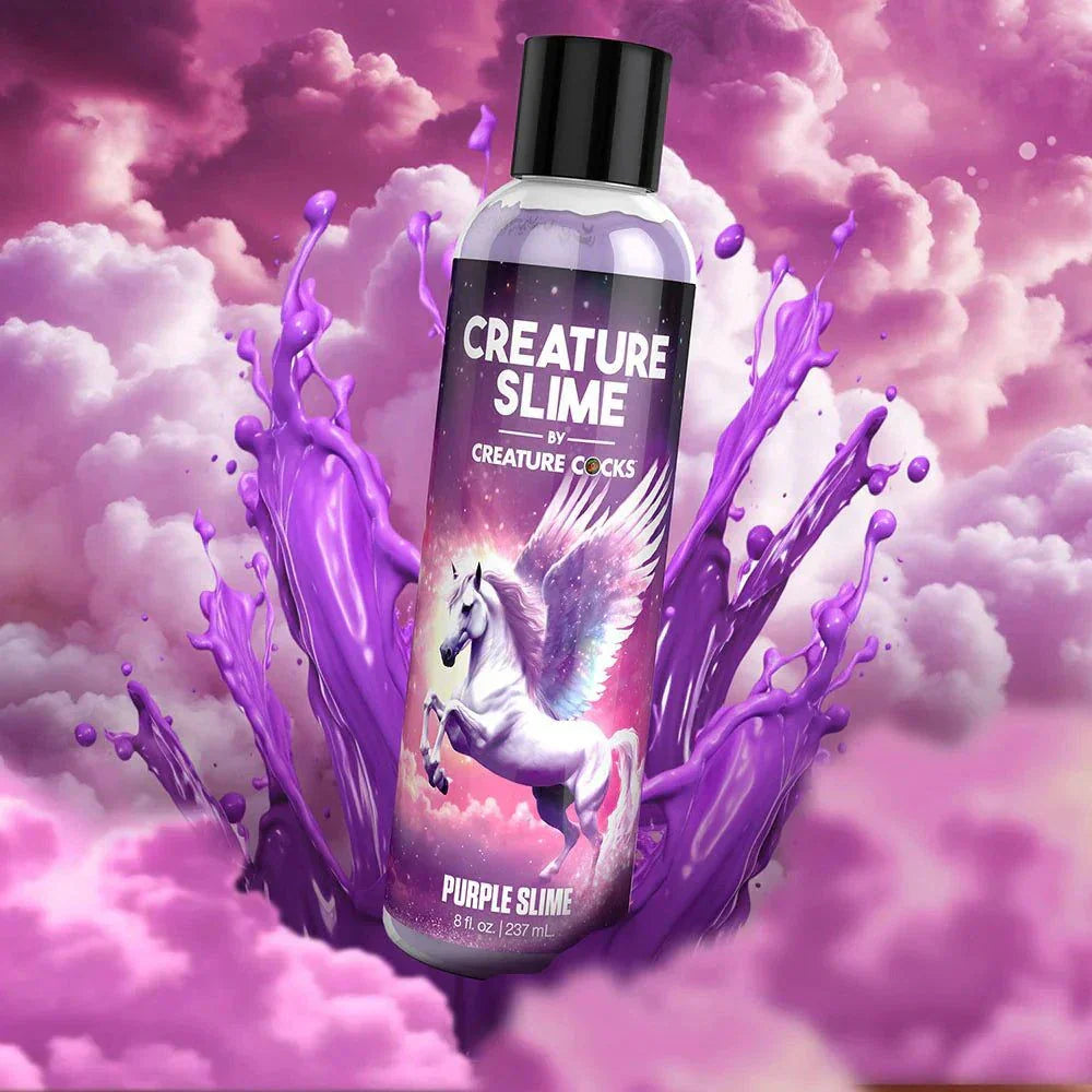 Creature Slime water-based lubricant bottle with unicorn design against a purple and pink mystical background.
