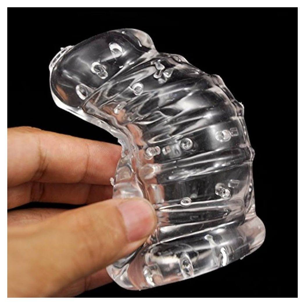 Master Series Detained clear soft body chastity cage held in hand showing flexibility and textured design