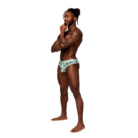 Man wearing Male Power Sheer Prints Thong with tropical design.