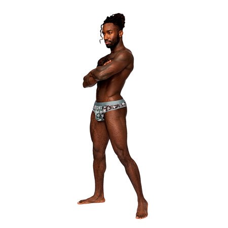 Male model wearing Male Power Sheer Prints Thong with bold design, showcasing fit and style.