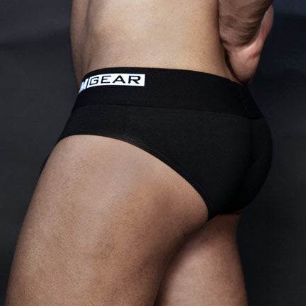 Rear view of a man wearing TIMGEAR Black Brief with a comfortable, sporty fit and branded waistband.